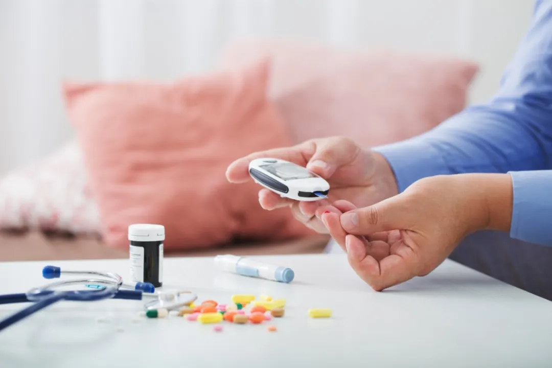Person checking blood glucose with a glucometer